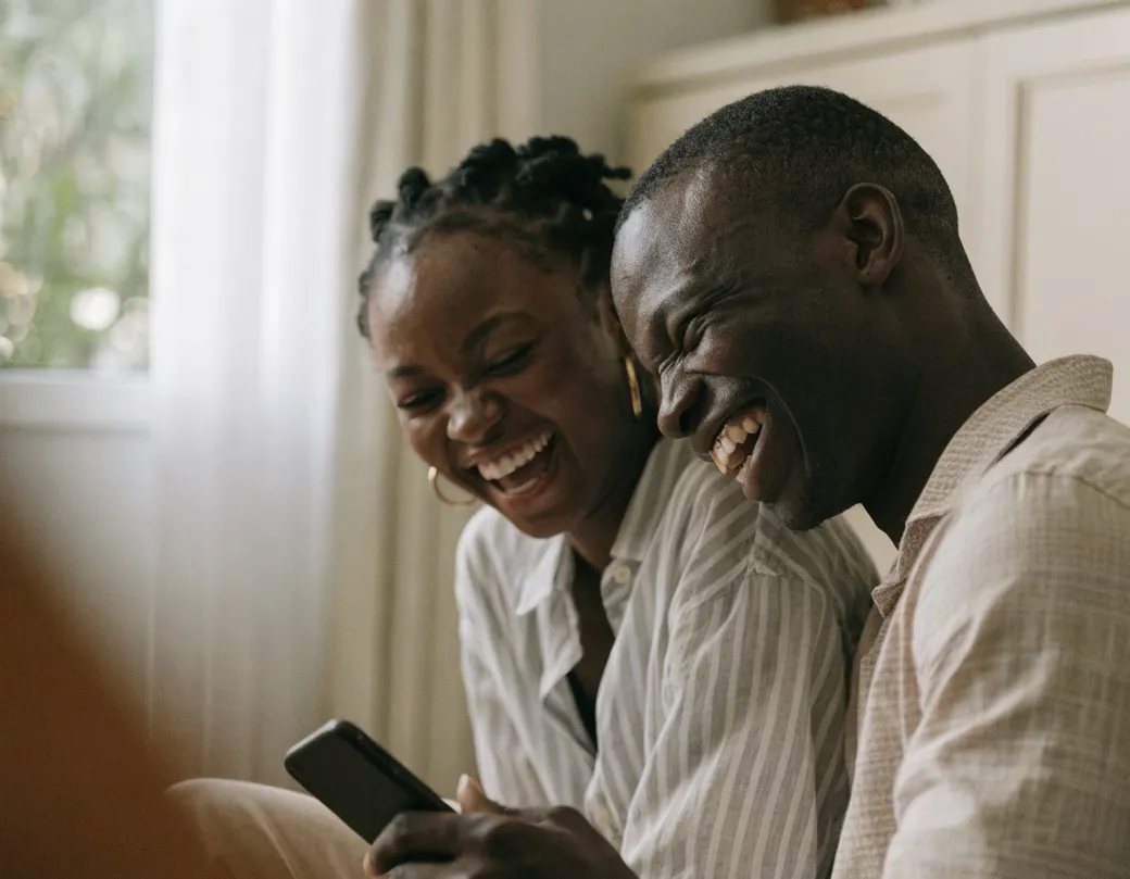 A couple looking at their wedding site together on a phone